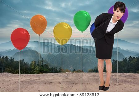 Surpised businesswoman bending against bright white room with windows