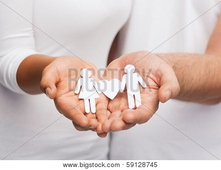 relationships and love concept - clousup of couple hands showing couple with heart shape