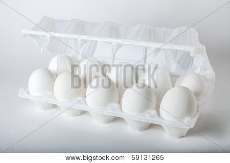 six eggs in a transparent plastic egg box