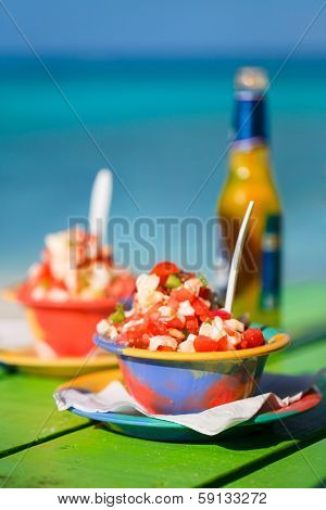 Two bowls of Bahamian conch salad and bottle of beer