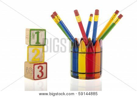 Collage Of Colourfull Pencils In A Cup Next To Three 1-2-3 Cubes