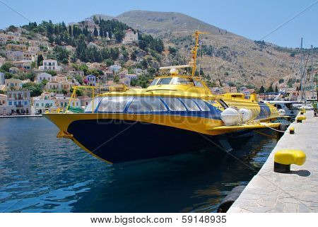 SYMI, GREECE - JUNE 19, 2011: Hydrofoil ferry Aegean Prince II docked in Yialos harbor on the Greek island of Symi. The Greek registered vessel was built in Georgia in 1981.