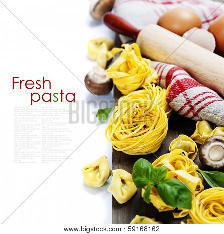 Fresh pasta and italian ingredients on wooden table (with easy removable sample text)