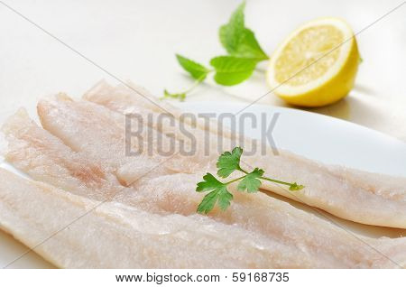 closeup of a plate with some raw pollack fillets
