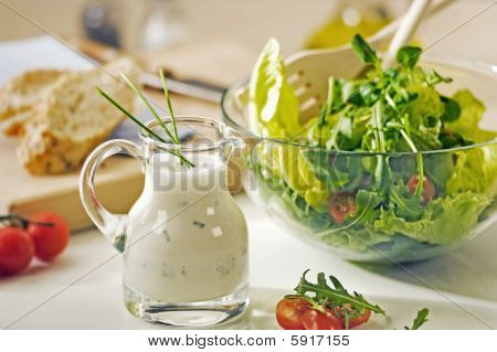 Skål gröna och en kruka sallad Dressing