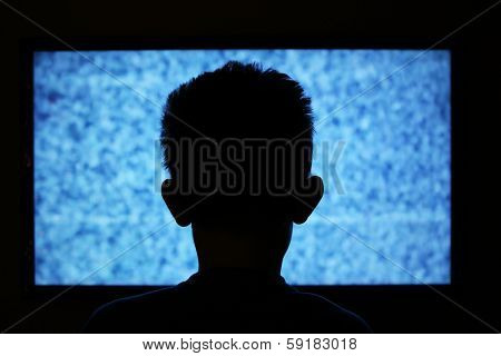 Boy watching television with noise