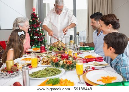 Extended family at dining table for christmas dinner in the house