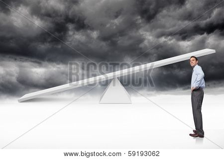 Smiling businessman with hand on hip against white scales in front of storm clouds