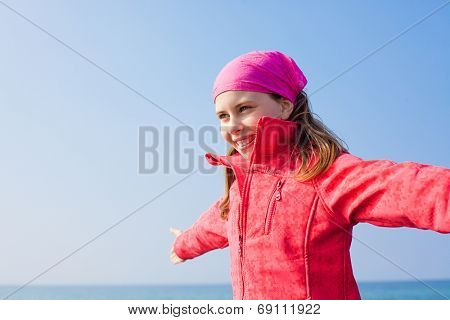 carefree little girl colder season autumn on the sea