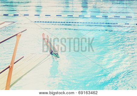 Diver entering the water (focus on the diving board)