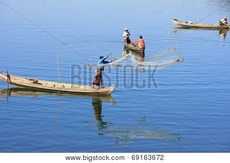AMARAPURA, MYANMAR - DECEMBER 31: Unidentified people fish in a lake on December 31, 2011 in Amarapu