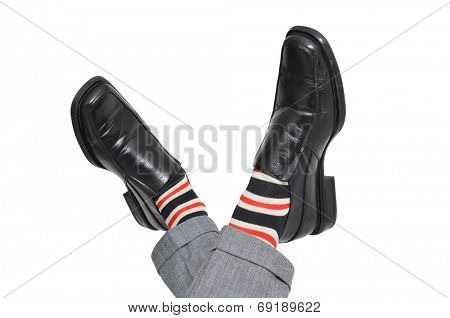 closeup of the crossed feet of a businessman who is relaxing, on a white background