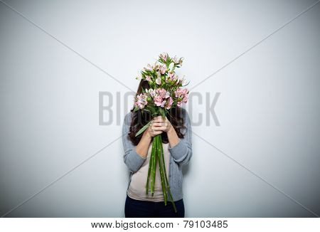 Young woman behind big bouquet
