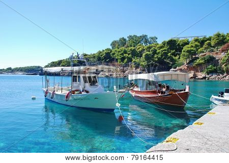 ALONISSOS, GREECE - SEPTEMBER 23, 2012: Small boats moored in Rousoum harbour on the Greek island of Alonissos. Rousoum was once the centre of the islands wine exporting trade.