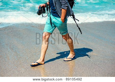 Man with photo camera on the beach