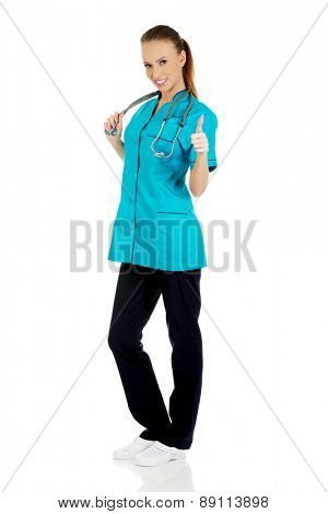 Beautiful smiling woman doctor with thumbs up.