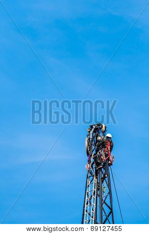 workers on electricity poles. a new power line will be built
