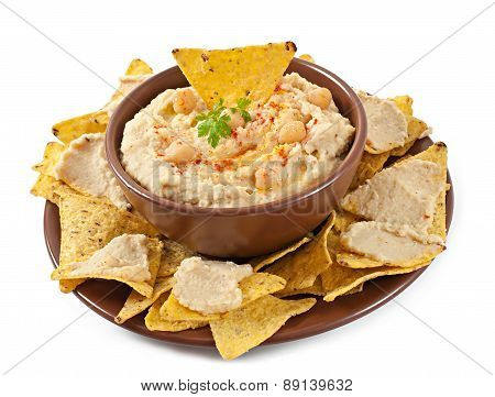 Healthy homemade hummus with olive oil and pita chips isolated on white background