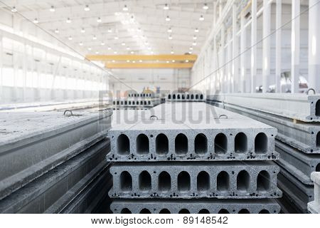 Stack of precast reinforced concrete slabs in a house-building factory workshop