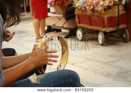 A Man Is Playing Tambourine At The Park