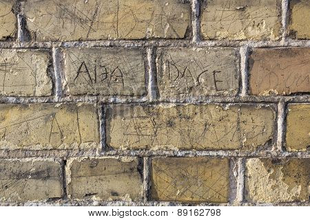 Old Brick Wall With Engraved Names