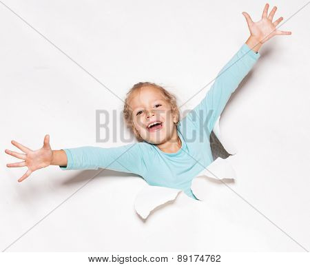 Child looking out of a hole. Banner. Happy girl