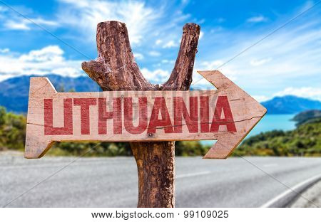 Lithuania wooden sign with road background