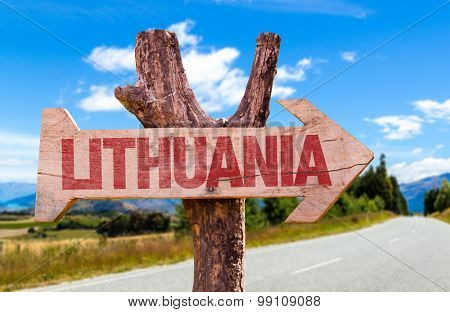 Lithuania wooden sign with road background
