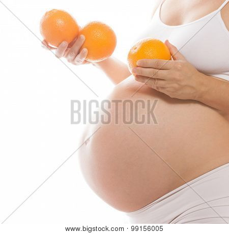 pregnant caucasian woman closeup body isolated on white background studio shot belly orange fruits healthy eating citrus diet