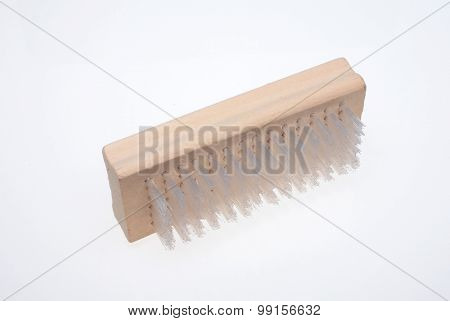 a nailbrush over white ground beauty product