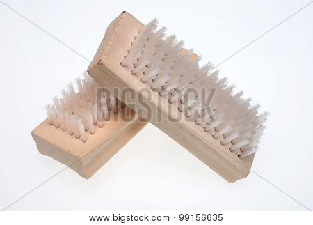 a nailbrush over white ground beauty product