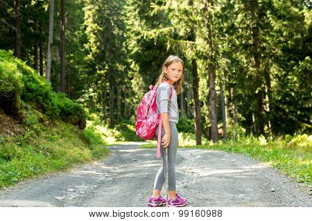 Little hiker girl in forest. Photo from Champex-Lac, Valais, swiss Alps