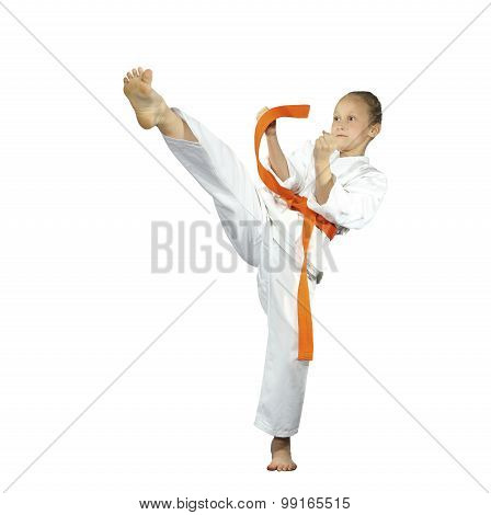 Sportswoman with an orange belt is beating mae-geri