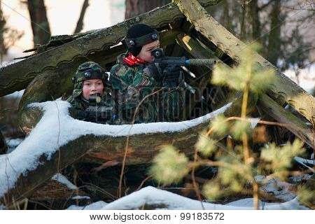 boys playing with gun during laser tag