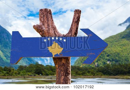 Kosovo Flag wooden sign with mountains on background