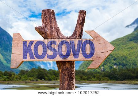 Kosovo wooden sign with mountains on background