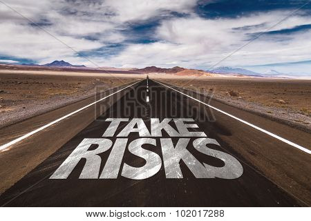 Take Risks written on desert road