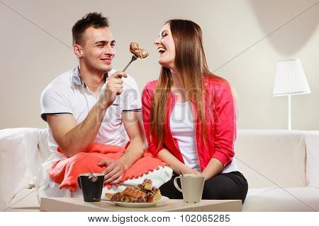 Smiling Man Feeding Happy Woman With Cake.