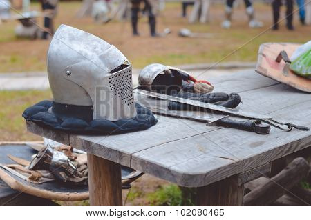 Closeup of medieval armors on old wooden table in countryside
