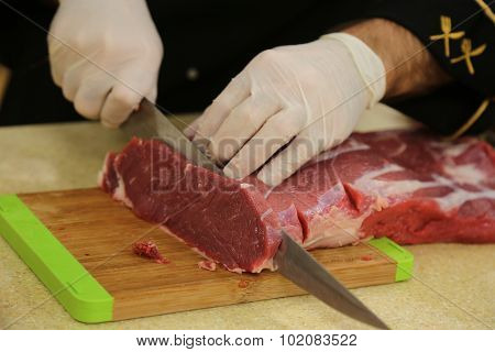 Butcher cutting meat