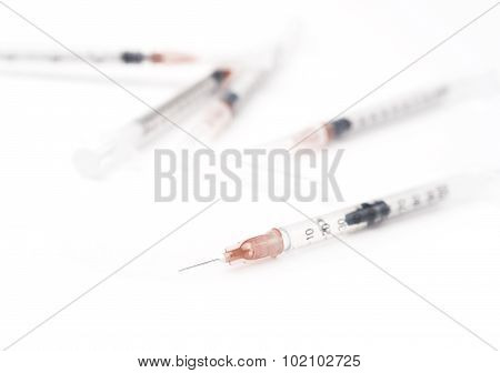 Five Disposable Syringes On The White Background