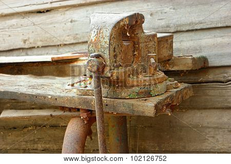 Old rustu all-steel vice on obsolete wooden workbench
