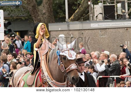 MUNICH, GERMANY - OCTOBER 19, 2015: a girl in the monk dress, which is the coat arm of Munich, in tent owners and breweries parade of Oktoberfest.