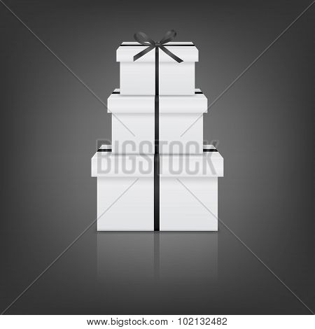 Stack of three realistic white gift boxes with black ribbon and bow