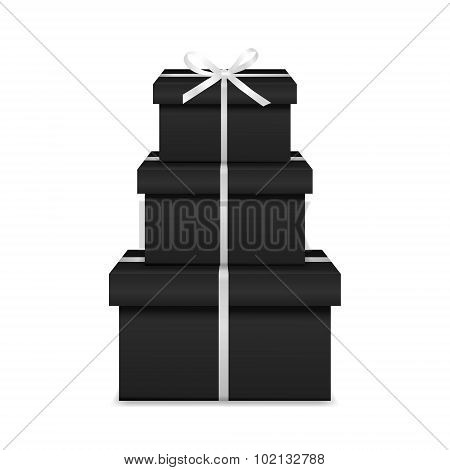 Stack of three realistic black gift boxes with white ribbon and bow