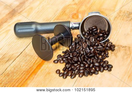 An Espresso Machine Group Head And Coffee Beans With Tamper.