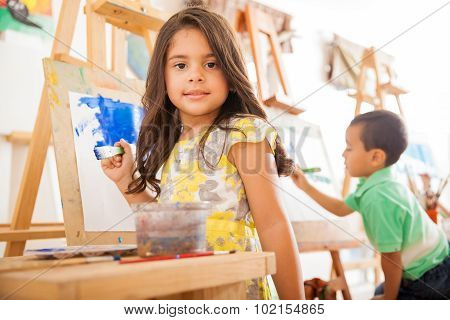 Hispanic Girl Painting In Art Class