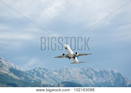 Airplane take off. Mountains view.