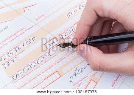 Male Hand Filling Remittance Slip