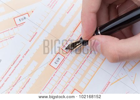 Male Hand Filling Remittance Slip